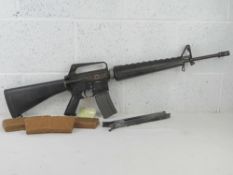 A deactivated moving bolt M16A1 assault rifle having detachable bipod, 3x M16 magazines,