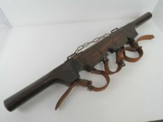 A WWII British Royal Artillery shell carrier having leather straps and dated 1943.