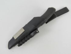 A Swedish Morakni Bushcraft survival knife in scabbard.