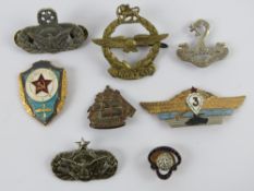 A WWII Rhodesia Air Force brass cap badge together with other military badges and an enamelled