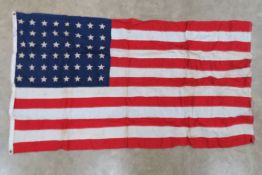 A US flag having 48 stars upon, sewn fabric construction, printed stars, 3' x 5', marked Premier.