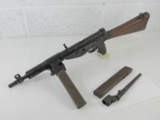 A deactivated Sten MK V 9mm sub machine gun with bayonet and spare magazine having moving cocking