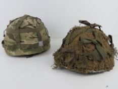 A WWII British Mk3 Turtle helmet having camo, liner and chin strap,