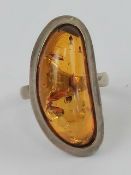 A silver and Baltic amber ring, 3cm wide, stamped 925, size P-Q.