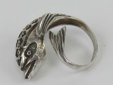 An unusual sculptural ring in the form of a dolphin, having carved detail and wrap around style,