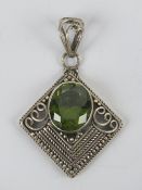 A large peridot and silver pendant, the central faceted peridot approx 1.4 x 1.