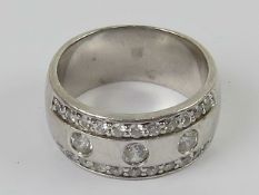 A silver ring designed by Zinzi, the wide band (9mm) set with cz stones,