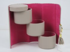 A leatherette jewellery box in the form of a clutch bag.