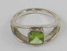 A silver and square faceted peridot ring, approx 0.9ct, stamped 925, size N.