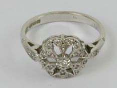 A 9ct white gold and diamond ring, the c