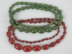 A set of graduated 1930s cherry amber coloured bakelite beads, partially individually knotted,