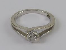 An 18ct white gold and diamond solitaire ring, the round cut brilliant diamond being 0.
