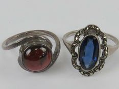 Two white metal rings, one with red cabachon size N,