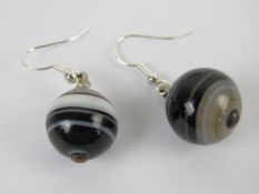 A pair of Victorian banded agate beads having new 925 silver earring hangers, 4cm drop.