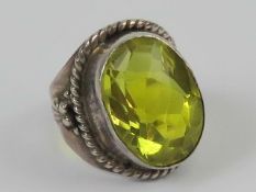 A handcrafted silver ring set with peridot coloured faceted stone, stamped 925, size J.