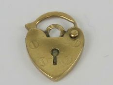 A 9ct gold heart padlock charm, 13mm in
