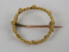 A yellow metal wreath brooch, no apparen
