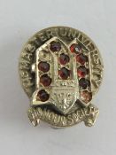 A 14ct white gold McMaster University Honour society badge, stamped 14k, 1.7g.