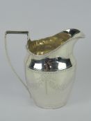 A Scottish George III HM silver jug having engraved floral swag decoration upon and central