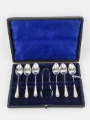 A cased set of HM silver teaspoons with associated sugar tongs, hallmarked Birmingham 1910,