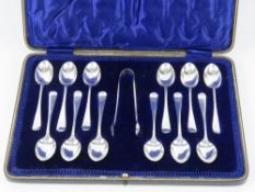 A boxed set of twelve HM silver teaspoons with associated HM silver sugar tongs,