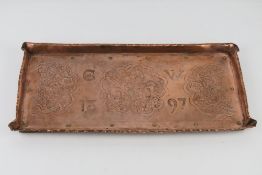 An arts and crafts hand engraved and shaped tray having mythical and Chinese influence creatures