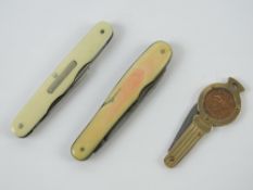 Two pocket knives having ivory handles and numerous blades.