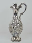 An impressive HM silver Victorian lidded carafe having acanthus leaf and foliate decoration