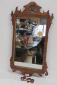 An early 19thC walnut framed wall mirror, pierced and carved throughout, a/f, 75 x 40cm.