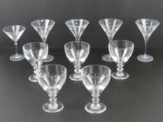 A quantity of five (four +one) cocktail glasses together with five sundae dishes.