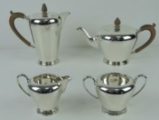 An Art Deco HM silver four piece tea service comprising teapot and coffee pot with wooden handles