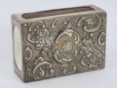 An HM silver matchbox cover having repousse floral design to front, measuring 7.6 x 5.2 x 2.