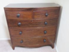 A late Victorian chest of two short over three long drawers, mahogany with turned ebonised handles,