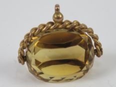 A large citrine spinning fob or pendant, warn marks (9c?), 3.4cm wide.