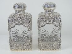 A delightful pair of William Comyns HM silver overlaid spirit decanters,