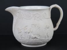 A cream ground pottery decorative jug having Classical scenes upon, impressed mark Turner to base,