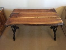 A West Sussex Oak and cast metal framed garden table, treated with Osmo oil and finished in beeswax,