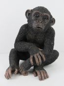 A resin figurine of a young chimp, 30cm high.