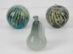 A pair of Mdina Maltese glass paperweights together with another small paperweight in the form of