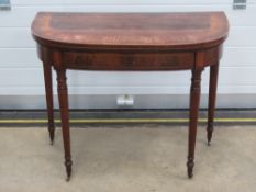 A good walnut and mahogany fold over Georgian games table opening to reveal baize interior,