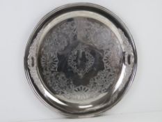 A large silver plated salver tray having floral repoussé border and further engraved floral