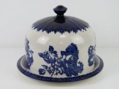 A blue and white ironstone cheese plate and cloche.