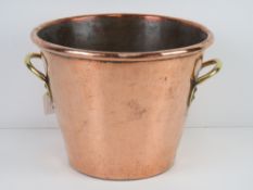 A fine copper jardiniere planter having brass side handles, 30cm dia, 22cm high.