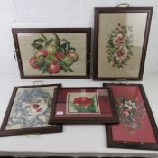 A quantity of five glazed and framed needlepoint panel trays, all with end handles, various sizes.