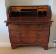 A good late Georgian half veneered mahogany fall front bureau,
