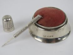 A silver pin cushion hallmarked Birmingham 1919, together with a HM silver pick, and a HG&S thimble.