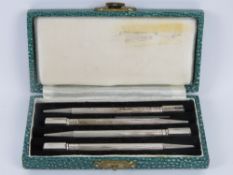 A delightful set of four Sterling silver bridge pencils in original presentation box, English made.