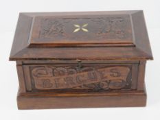 A decorative mahogany lidded box having blind carving and inset bone to top,