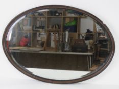 A good oval bevel edged rosewood framed over mantle mirror 80 x 56cm.