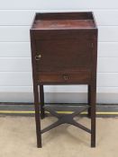 A late Georgian mahogany pot cupboard having single cupboard door with drawer under,
